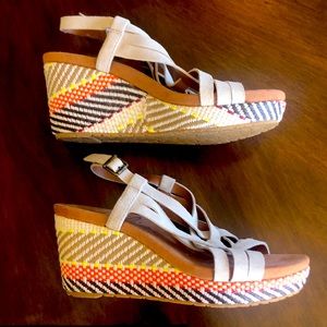 Beige straps, multi colored wedge heels. Tan soles.